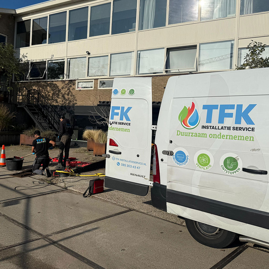 Man Using Measuring Tape in Factory Setting Man Using Measuring Tape in Factory Setting